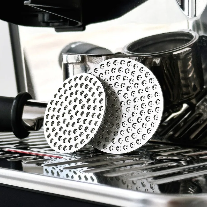 Stainless steel espresso puck screens on an espresso machine