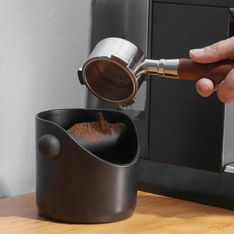 Knocking a used espresso puck into a knock box